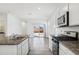 Modern kitchen with granite counters and stainless steel appliances at 40020 W Hillman Dr, Maricopa, AZ 85138