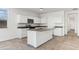 White kitchen cabinets, granite countertops, and an island with a sink at 40055 W Venture Rd, Maricopa, AZ 85138