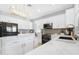 Bright kitchen featuring white cabinets, marble countertops, and a large island at 40308 N High Noon Way, Phoenix, AZ 85086