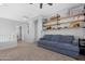 Loft area with gray couch and built-in shelving at 40308 N High Noon Way, Phoenix, AZ 85086