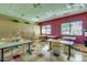 Art studio with easels, tables, and storage cabinets at 42493 W Candyland Pl, Maricopa, AZ 85138