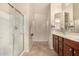 Bathroom with double sinks, shower, and tile flooring at 42493 W Candyland Pl, Maricopa, AZ 85138