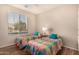 Bedroom with two twin beds and large window at 42493 W Candyland Pl, Maricopa, AZ 85138