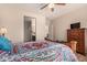 Bright bedroom with wood flooring and a ceiling fan at 42493 W Candyland Pl, Maricopa, AZ 85138