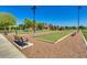 Outdoor bocce ball courts with benches at 42493 W Candyland Pl, Maricopa, AZ 85138