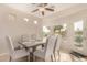 Dining area with a large table and chairs, overlooking the backyard at 42493 W Candyland Pl, Maricopa, AZ 85138