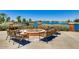 Fire pit with seating overlooking lake at 42493 W Candyland Pl, Maricopa, AZ 85138