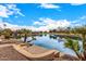 Stunning lakefront view with a paved seating area at 42493 W Candyland Pl, Maricopa, AZ 85138