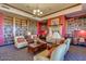 Community library with comfortable seating and a fireplace at 42493 W Candyland Pl, Maricopa, AZ 85138