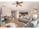 Open living room with gray sofa and view into kitchen area at 42493 W Candyland Pl, Maricopa, AZ 85138