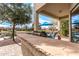 Outdoor kitchen with built-in grill and lake view at 42493 W Candyland Pl, Maricopa, AZ 85138