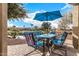 Enjoy lake views from this relaxing patio, featuring comfortable seating and an umbrella at 42493 W Candyland Pl, Maricopa, AZ 85138