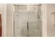 Clean shower with glass enclosure and built-in shelving at 42493 W Candyland Pl, Maricopa, AZ 85138