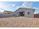 A backyard with a covered patio extending from the house, offering space for outdoor entertaining and relaxation at 46941 W Old Timer Rd, Maricopa, AZ 85139