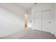 Bedroom with sliding door closet, neutral carpet, and white walls at 46941 W Old Timer Rd, Maricopa, AZ 85139