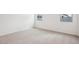 This bright bedroom features neutral carpet, white walls, and a pair of windows at 46941 W Old Timer Rd, Maricopa, AZ 85139
