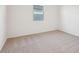 Bedroom with neutral carpet, white walls, and a window at 46941 W Old Timer Rd, Maricopa, AZ 85139