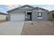 Charming single-story home with a well-maintained front yard and a two-car garage at 46941 W Old Timer Rd, Maricopa, AZ 85139