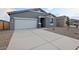 Beautiful home featuring a spacious driveway and low-maintenance desert landscaping at 46941 W Old Timer Rd, Maricopa, AZ 85139