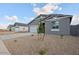 Attractive home with a two-car garage, xeriscaping, and a freshly planted tree in the yard at 46941 W Old Timer Rd, Maricopa, AZ 85139