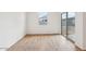 Bright living room features wood-look tile flooring and a sliding glass door at 46941 W Old Timer Rd, Maricopa, AZ 85139