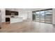 Light-filled living space with a kitchen featuring an island and sliding glass doors to the backyard at 46941 W Old Timer Rd, Maricopa, AZ 85139