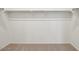 Spacious walk-in closet with carpeted floors and rod for hanging clothes at 46941 W Old Timer Rd, Maricopa, AZ 85139