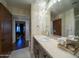 Elegant bathroom with dark wood vanity, a large mirror and a view of the bedroom at 4909 N Woodmere Fairway -- # 2003, Scottsdale, AZ 85251