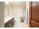 Traditional bathroom with a tiled floor, single sink vanity, and enclosed tub shower at 4909 N Woodmere Fairway -- # 2003, Scottsdale, AZ 85251