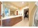 Bathroom featuring a large vanity with double sinks, soft colors, and a walk-in closet at 4909 N Woodmere Fairway -- # 2003, Scottsdale, AZ 85251