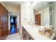 Stylish bathroom with a single vanity and neutral tones that continue into the bedroom beyond at 4909 N Woodmere Fairway -- # 2003, Scottsdale, AZ 85251