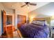 Bedroom featuring a ceiling fan, and a bed with a luxurious purple patterned duvet and decorative pillows at 4909 N Woodmere Fairway -- # 2003, Scottsdale, AZ 85251