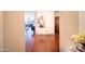 Inviting hallway with gleaming hardwood floors, leading to a spacious living area and a charming view of the interior at 4909 N Woodmere Fairway -- # 2003, Scottsdale, AZ 85251