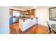 Contemporary kitchen features stainless steel appliances, dark wood cabinetry, granite counters, and hardwood flooring at 4909 N Woodmere Fairway -- # 2003, Scottsdale, AZ 85251