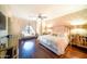 This main bedroom has elegant wallpaper, wood floors, and a seating area near the window at 4909 N Woodmere Fairway -- # 2003, Scottsdale, AZ 85251