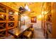 Unique wine cellar with stone walls, custom storage, and spiral staircase at 4909 N Woodmere Fairway -- # 2003, Scottsdale, AZ 85251