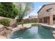 Beautiful backyard with a pool, waterfall, and lush landscaping at 5102 E Charleston Ave, Scottsdale, AZ 85254