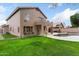 Sprawling backyard featuring a private pool and waterfall, covered patio, and grass at 5102 E Charleston Ave, Scottsdale, AZ 85254