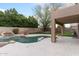 Resort-style backyard featuring a pool, waterfall, and lush landscaping at 5102 E Charleston Ave, Scottsdale, AZ 85254