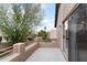 Private balcony with sliding glass doors offers serene views of the lush backyard and nearby neighborhood at 5102 E Charleston Ave, Scottsdale, AZ 85254