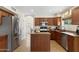 Well-equipped kitchen with stainless steel appliances, granite countertops, and a central island at 5102 E Charleston Ave, Scottsdale, AZ 85254
