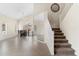 Spacious living area with tile floors, a dining table, a ceiling fan, and staircase to the upper level at 5102 E Charleston Ave, Scottsdale, AZ 85254