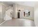 Bright living room with high ceilings, tile flooring, a staircase, and a large window at 5102 E Charleston Ave, Scottsdale, AZ 85254