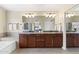 Main bathroom features a dual sink vanity, large mirror, separate bathtub, and shower area at 5102 E Charleston Ave, Scottsdale, AZ 85254