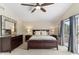 Comfortable main bedroom with a large window, wood furniture, soft lighting, and a calming ambiance at 5102 E Charleston Ave, Scottsdale, AZ 85254