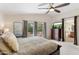 Inviting main bedroom with balcony access, ceiling fan, and en-suite bath entrance at 5102 E Charleston Ave, Scottsdale, AZ 85254