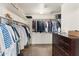 Organized walk-in closet with ample storage space, built-in shelving, and a dark wood dresser at 5102 E Charleston Ave, Scottsdale, AZ 85254