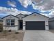 One-story house with dark gray garage door and light-colored exterior at 549 W Freedom St, Florence, AZ 85132