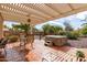 Covered patio with hot tub, seating, and terracotta tile flooring at 5965 E Teton Cir, Mesa, AZ 85215