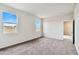 Well-lit bedroom featuring carpet, and two windows at 641 W Freedom St, Florence, AZ 85132